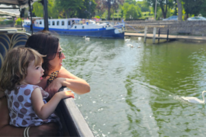 mamma e figlia su una barca guardano il panorama